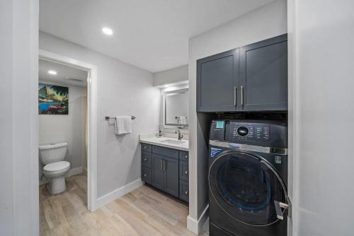 a bathroom with a washing machine and a sink at Eldorado K104 · EL K104 Spacious 1BD w Near Beach in Kahana
