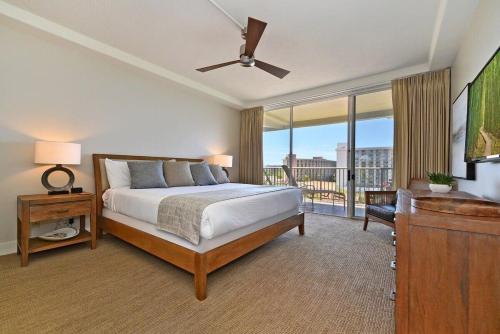 ラハイナにあるWhaler 859 BeachFront Luxury Condo w Ocean Viewsのベッドとバルコニーのある寝室