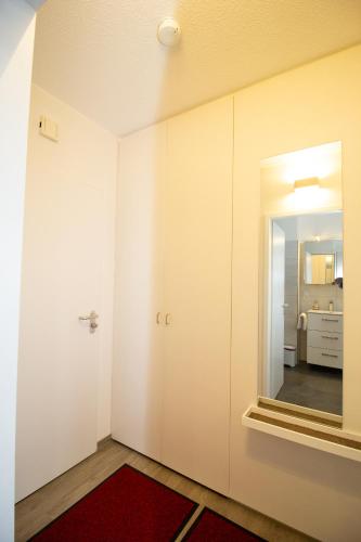 an empty room with a door and a mirror at Deichgraf 345 in Döse