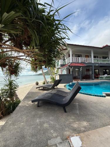 a resort with a swimming pool and a house at Mr. Black Resort in Haad Rin