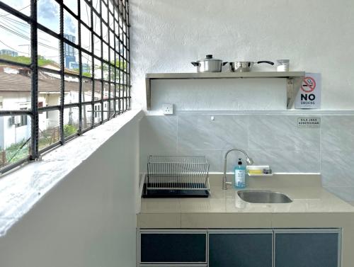 a kitchen with a sink and a window at Comfort Homestay JB Town near CIQ in Johor Bahru