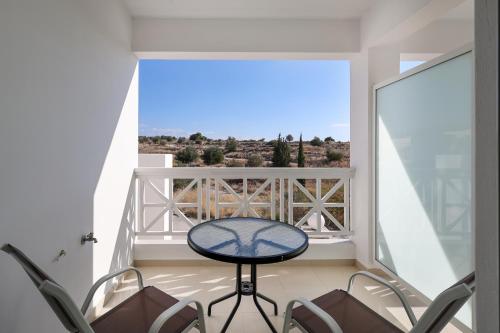 a balcony with a table and chairs and a view at Perdika Residences in Perdika