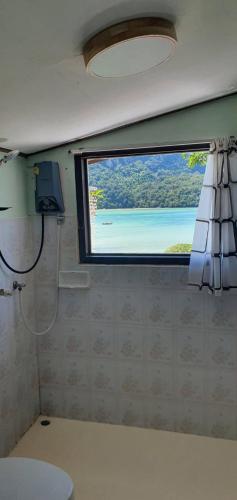 a bathroom with a window with a view of the ocean at Phi Phi View Point Resort in Phi Phi Islands