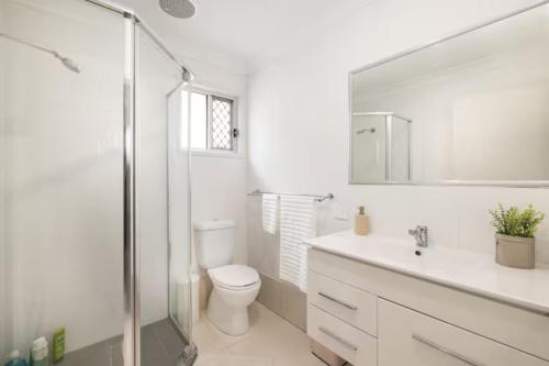 a bathroom with a toilet and a sink and a shower at Smart Suites Self Check-in Apartments - S Freney in Brisbane