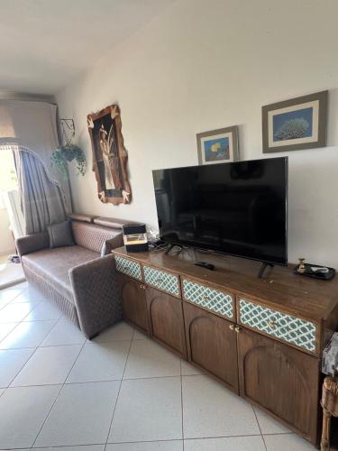 a living room with a flat screen tv and a couch at Sea View Apartment with Full kitchen and living room in Sharm El Sheikh