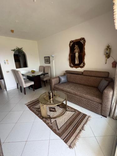 a living room with a couch and a table at Sea View Apartment with Full kitchen and living room in Sharm El Sheikh