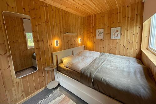 a bedroom with a bed in a wooden cabin at House on Dundret in Gällivare