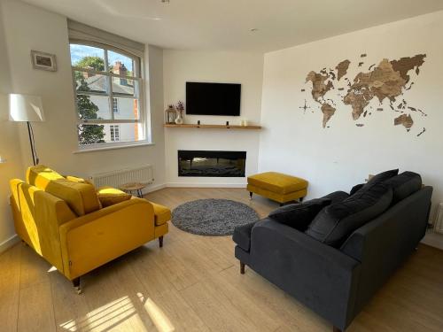 a living room with two couches and a tv at Luxury City Centre Apartment, Winchester in Winchester