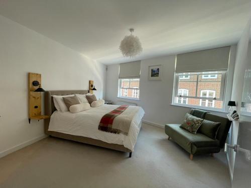 a bedroom with a bed and a chair at Luxury City Centre Apartment, Winchester in Winchester