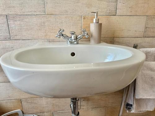 a white sink in a bathroom with a candle at Stura Home in Rome