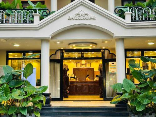 a front door of a house with plants at Sala Hoi An Hotel in Hoi An