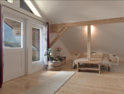 a bedroom with a bed and a large window at Apartment - Sleeps 3 - Balcony - Garden in Feldkirch