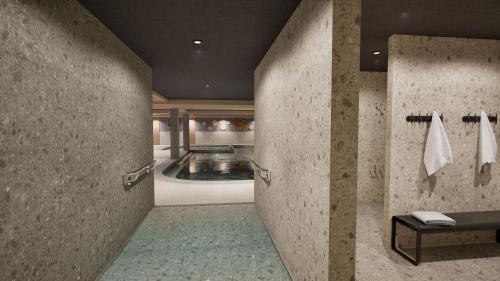 a bathroom with a swimming pool in the background at Résidence Odalys L'Ecrin Blanc in Montvalezan