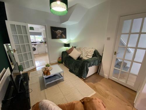 a living room with a couch and a table at Mercer House in Lisburn