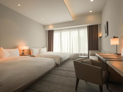 Postel nebo postele na pokoji v ubytování Hotel COZZI Zhongshan Kaohsiung