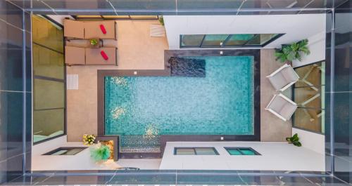 an overhead view of a house with a swimming pool at Cheeky monkey villa in Nong Prue