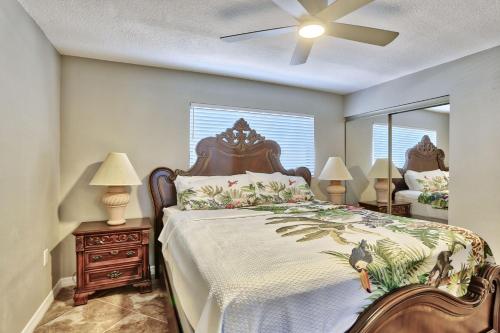 a bedroom with a bed and a ceiling fan at Sunset Chateau 506 - Premier in St. Pete Beach