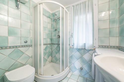 a bathroom with a shower and a toilet and a sink at Seb beach in Costa Rei