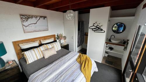 a bedroom with a bed and a sink in it at Ocean Views - Ocean Grove, Spectacular Family Home in sought after Location in Ocean Grove
