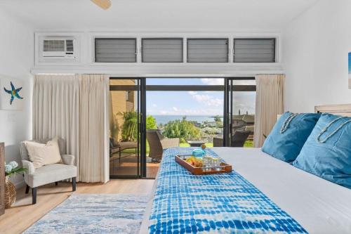 a bedroom with a bed with a tray of food on it at Kapalua Ridge Villas 1612 · KRV 1612 Remodeled Kapalua Villa w O in Kahana