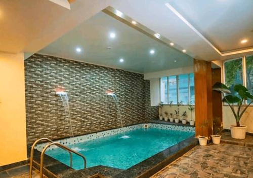 a large swimming pool in a room with at Hotel the shore by Trindra Hospitality in Rishīkesh