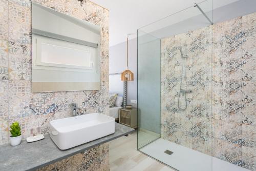 a bathroom with a sink and a shower at Villa Marnes by Menorca Vacations in Son Bou