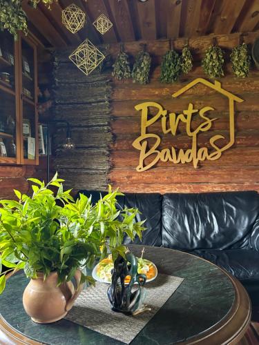 a dining room with a table with plants on it at Pirts Baudas in Sīveci