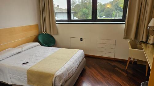 Ένα ή περισσότερα κρεβάτια σε δωμάτιο στο Country Hotel Borromeo