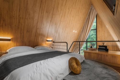Un dormitorio con una cama grande con una ventana grande. en VERDANT HAVEN, en Jiezi Ancient Town