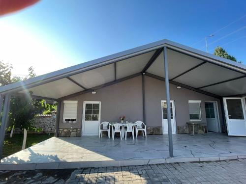a pavilion with a table and chairs on a patio at Villa Milla in Veles