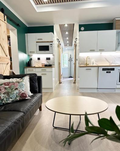 a living room with a couch and a table at Hidden gem near Fiskars and Billnäs in Raseborg