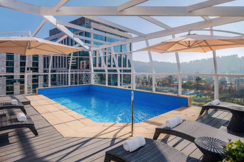 a swimming pool with umbrellas on a building at Four Points by Sheraton Santiago in Santiago