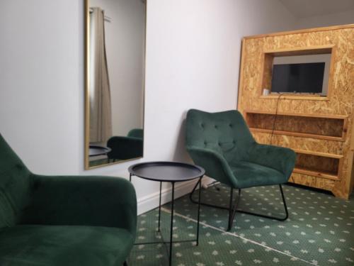 a room with two chairs and a table and a mirror at 1Bed-ContactlessCheckIn-OutdoorSpace in Cork