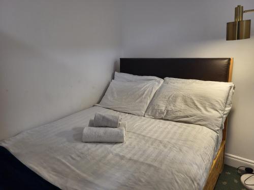 a bed with two pillows on top of it at 1Bed-ContactlessCheckIn-OutdoorSpace in Cork