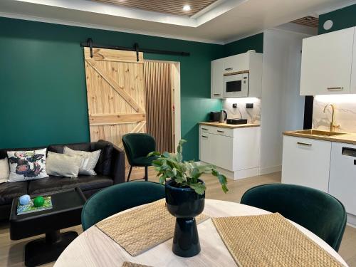 a living room with a table and a couch and a kitchen at Hidden gem near Fiskars and Billnäs in Raseborg