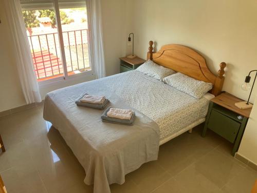 a bedroom with a bed with two towels on it at Villa garden and sea in Alicante