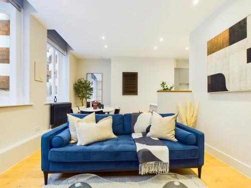 a blue couch in a living room at Be London - The Piccadilly Circus Residences in London