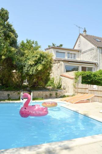 a pink flamingo float in a swimming pool at Docatange in Boisgasson