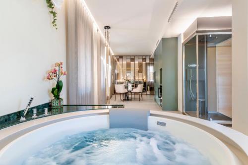 a jacuzzi tub in the middle of a room at Syrmioncello - Castle Lounge in Sirmione