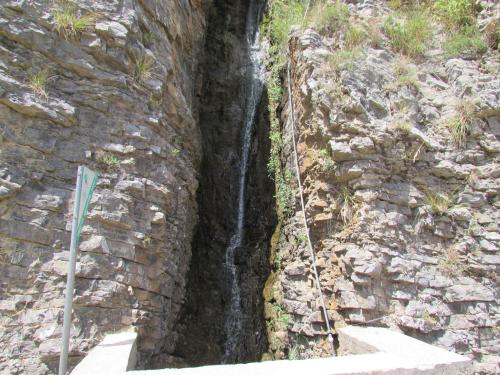 a waterfall on the side of a stone wall at B&B Serena in Longi