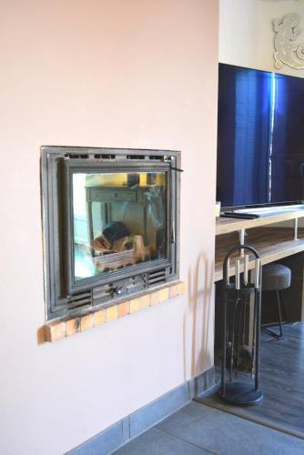 a fireplace in the corner of a room at La Serenidad in Denonville