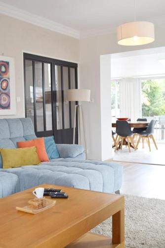 a living room with a blue couch and a table at La Milena in Morancez