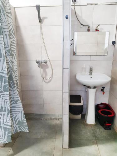 a bathroom with a sink and a shower at mHostel24 in Lublin