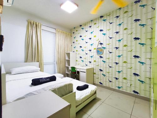 a bedroom with two beds and a wallpaper with birds at AZ 3Rooms Apartment at De Centrum Bangi-Putrajaya in Kajang