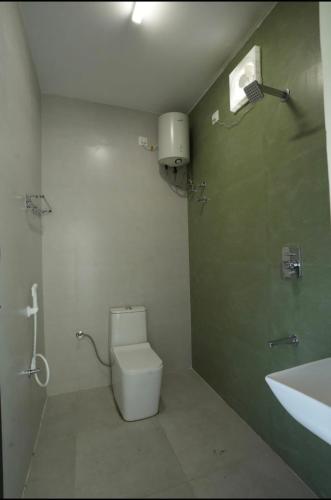 a bathroom with a toilet and a sink at Keerthana Marriage hall and Rooms in Coimbatore