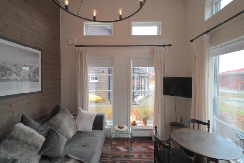 a living room with a couch and a table at Mountain Cabin with Ski-in Access in Björnrike 