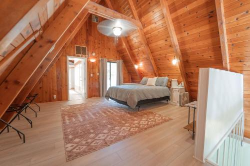 a bedroom with a bed in a wooden cabin at Sequoia Vintage A-frame River Retreat in Three Rivers