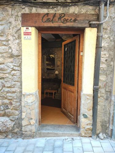 an entrance to a building with a wooden door at CAL ROCCO Porta del Pirineu in La Pobla de Segur