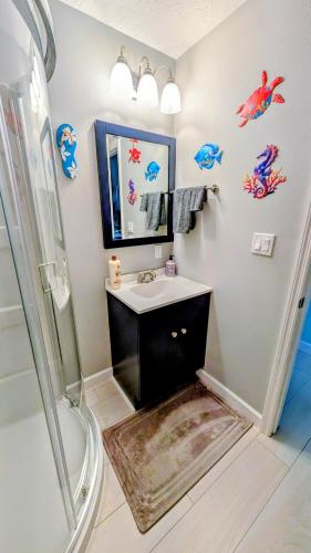 a bathroom with a sink and a shower at Merritt Island hideaway in Merritt Island