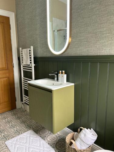 a bathroom with a sink and a mirror at LAKE VIEW Luxury Apartment in Dunfanaghy